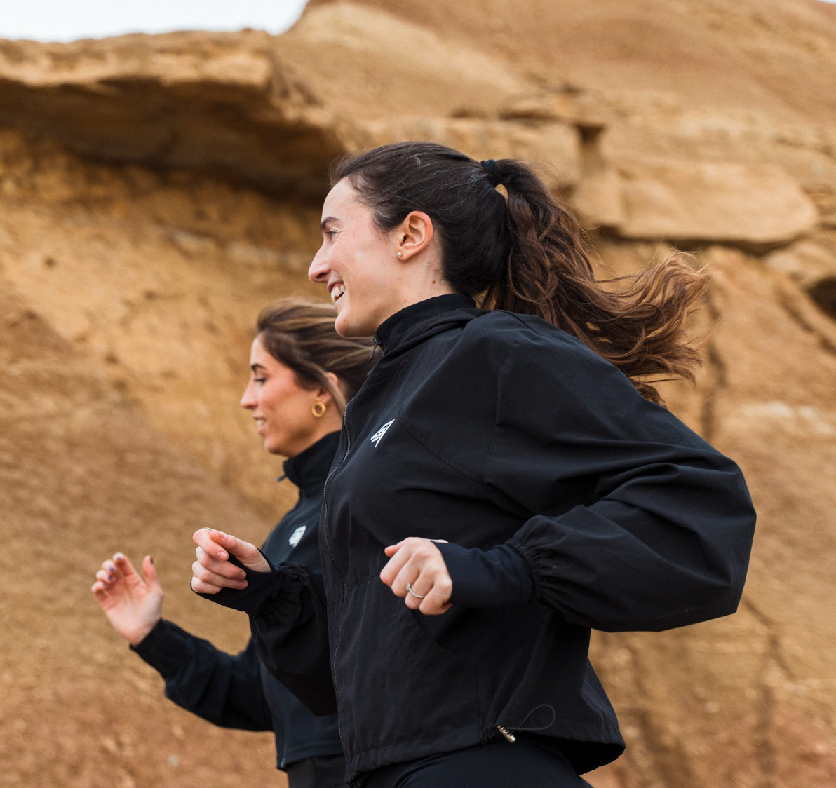 Women running in the desser in black THR9VE clothes