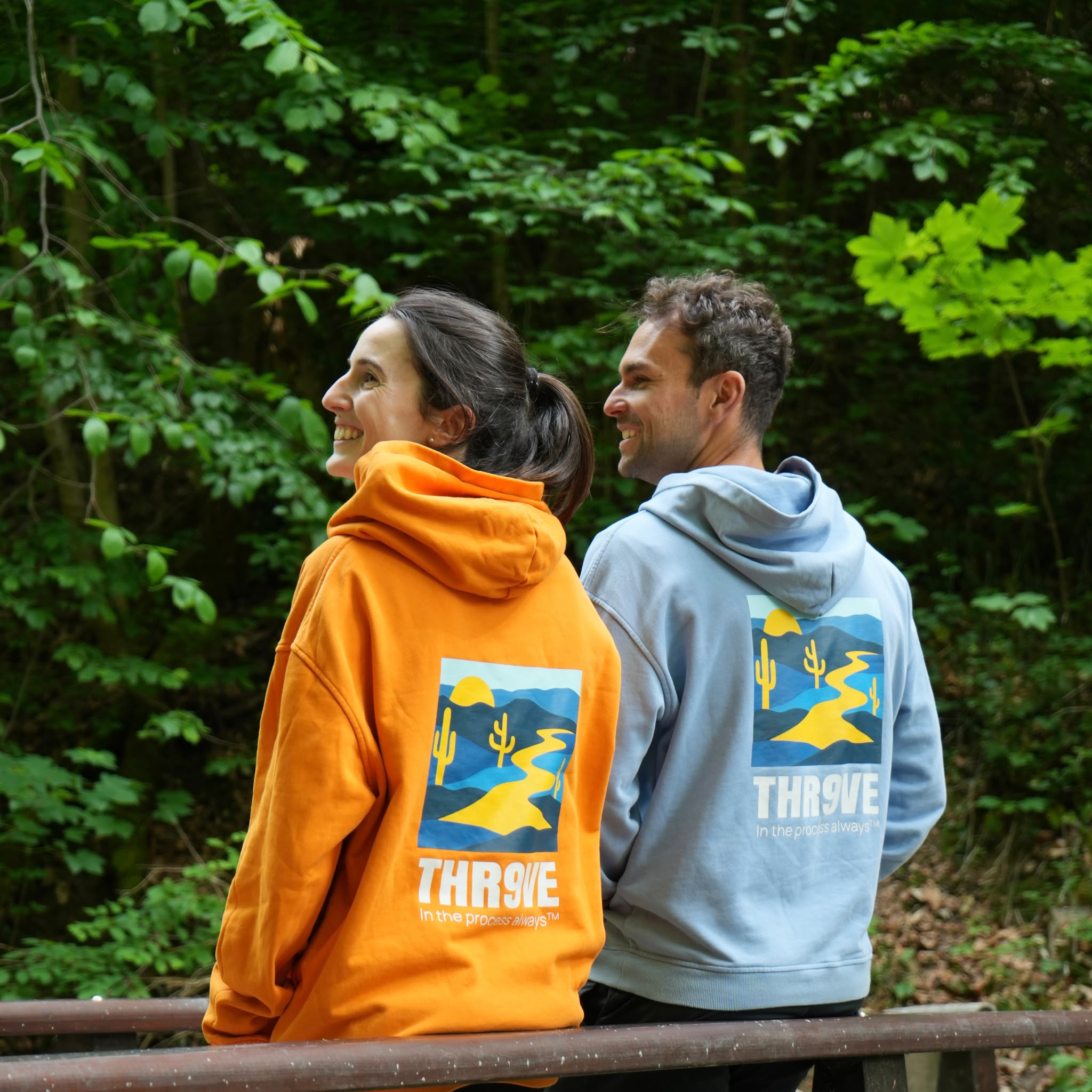 THR9VE Organic Cotton Hoodie in dusty sky blue and warm orange — lifestyle shot
