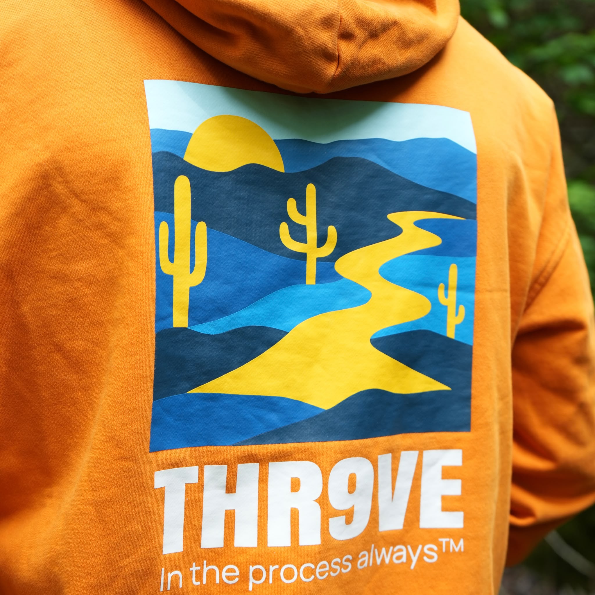 THR9VE Organic Cotton Hoodie in warm orange — back view, lifestyle shot 3