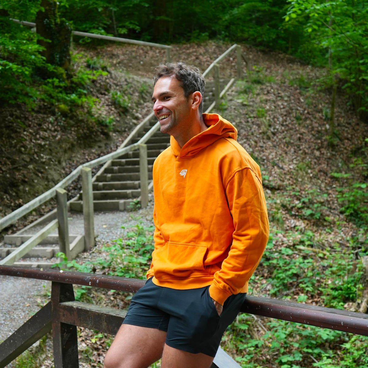 THR9VE Organic Cotton Hoodie in warm orange — front view, lifestyle shot